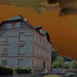 House in Neunkirchen in front of orange sky.