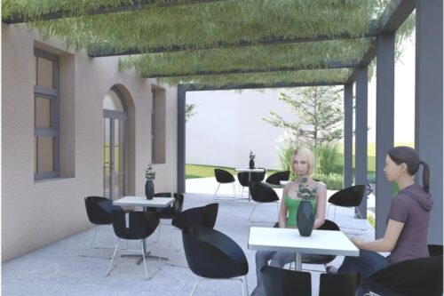 Die Terrasse des Cafes mit tischen. Hier sitzen 2 Frauen.